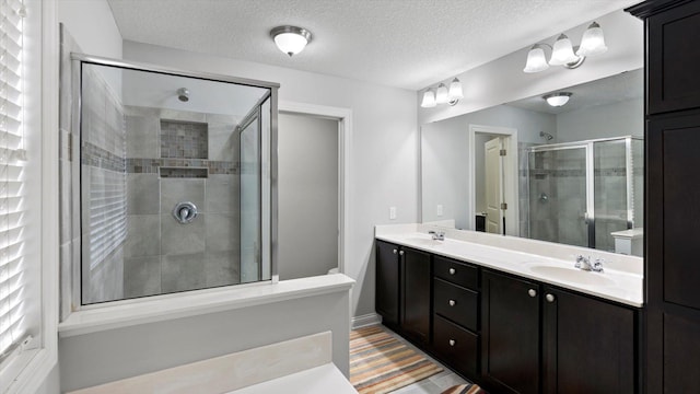15365 Eagle Creek Way, Apple Valley, MN 55124 - bathroom with a stall shower, a textured ceiling, double vanity, and toilet