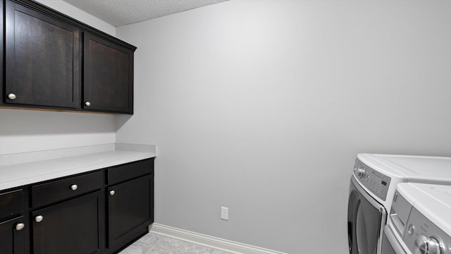 15365 Eagle Creek Way, Apple Valley, MN 55124 - washroom with cabinet space, separate washer and dryer, a textured ceiling, and baseboards