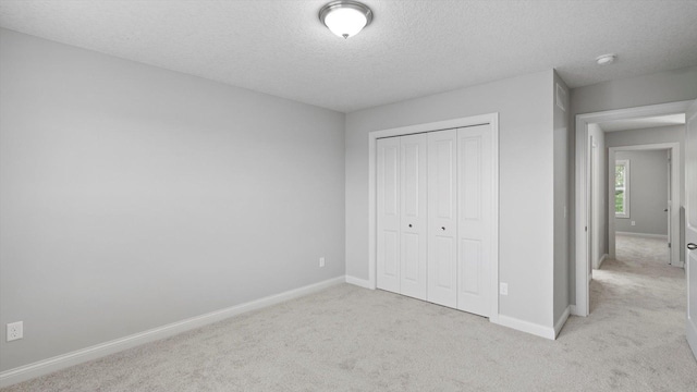 15365 Eagle Creek Way, Apple Valley, MN 55124 - unfurnished bedroom featuring carpet flooring, a textured ceiling, baseboards, and a closet