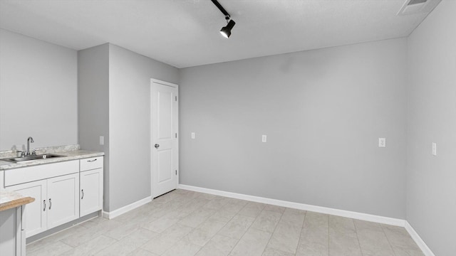 15365 Eagle Creek Way, Apple Valley, MN 55124 - interior space with a sink, baseboards, and rail lighting