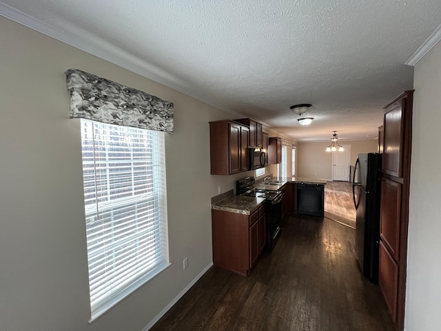 kitchen featuring black appliances, dark wood finished floors, healthy amount of natural light, crown molding, and a textured ceiling
