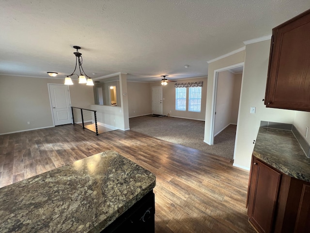 living area with dark wood finished floors, ornamental molding, baseboards, and a textured ceiling