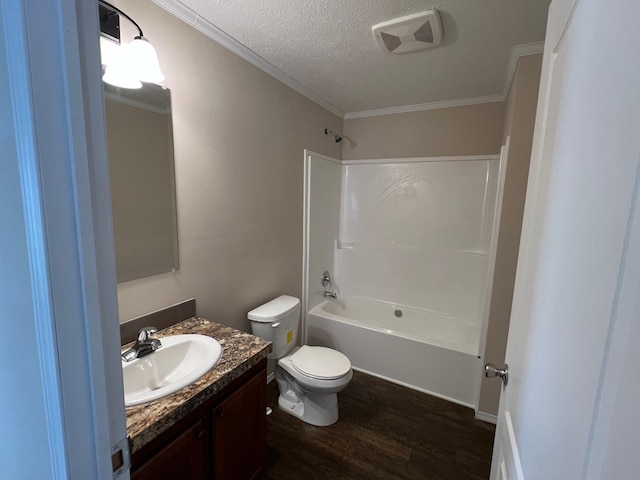 full bathroom featuring wood finished floors, toilet, vanity, bathtub / shower combination, and a textured ceiling