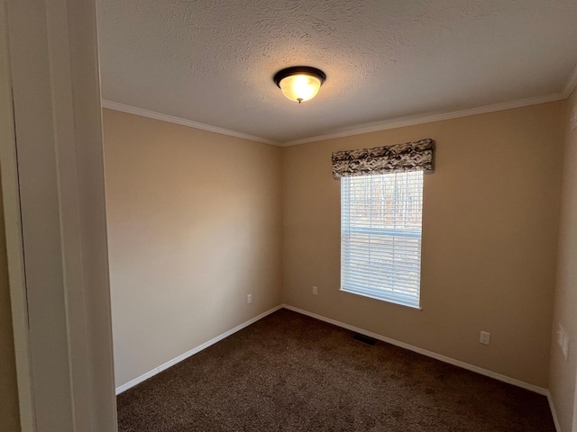 spare room with crown molding, dark colored carpet, a textured ceiling, and baseboards