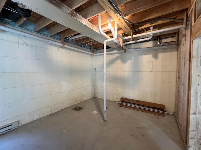 unfinished below grade area featuring a baseboard heating unit