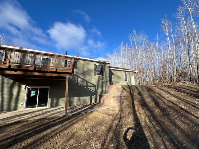 rear view of house with a wooden deck