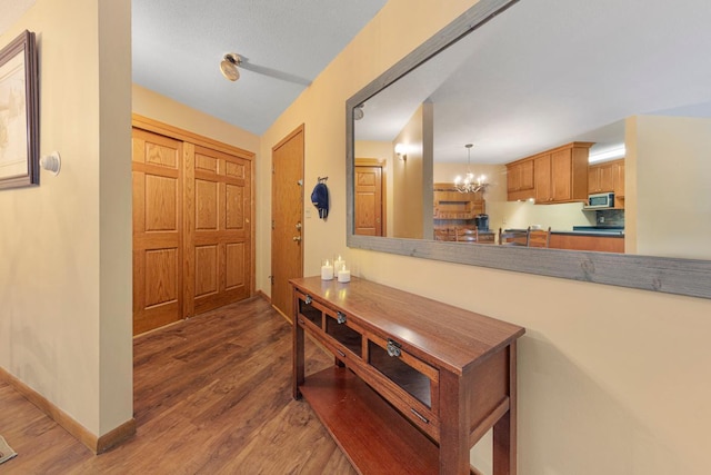 5450 Three Points Blvd Unit 623, Mound, MN 55364 - entrance foyer with wood finished floors, a chandelier, and baseboards