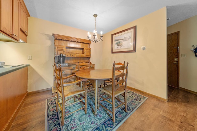 5450 Three Points Blvd Unit 623, Mound, MN 55364 - dining room with light wood-type flooring, a chandelier, and baseboards