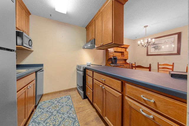 5450 Three Points Blvd Unit 623, Mound, MN 55364 - kitchen with appliances with stainless steel finishes, under cabinet range hood, dark countertops, brown cabinetry, and a textured ceiling