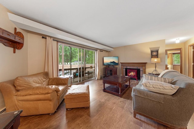 5450 Three Points Blvd Unit 623, Mound, MN 55364 - living room with a brick fireplace, light wood finished floors, and healthy amount of natural light