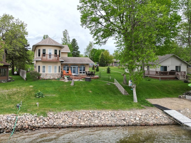 14620 Thomas Rd, Lake Park, MN 56554 - rear view of property with a balcony, stucco siding, a deck, stone siding, and a yard