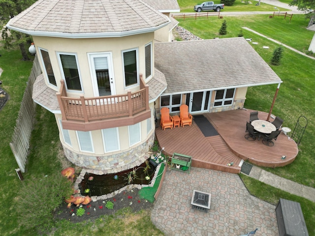 14620 Thomas Rd, Lake Park, MN 56554 - rear view of property featuring a wooden deck, stucco siding, stone siding, roof with shingles, and outdoor dining space