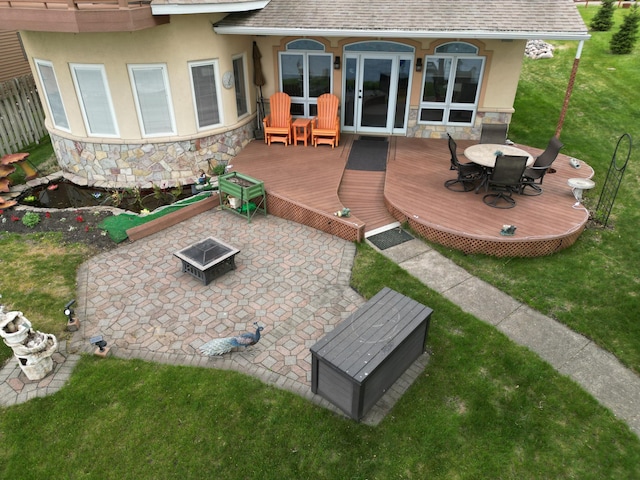 14620 Thomas Rd, Lake Park, MN 56554 - deck featuring a fire pit, a lawn, and outdoor dining space
