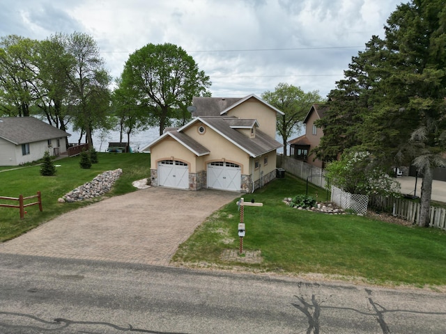 14620 Thomas Rd, Lake Park, MN 56554 - view of front of home with stucco siding, stone siding, driveway, and an attached garage