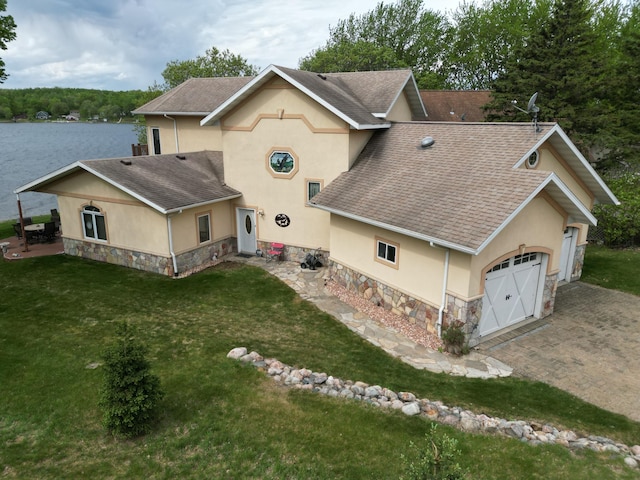 14620 Thomas Rd, Lake Park, MN 56554 - view of front facade featuring stone siding, stucco siding, roof with shingles, a garage, and a front lawn
