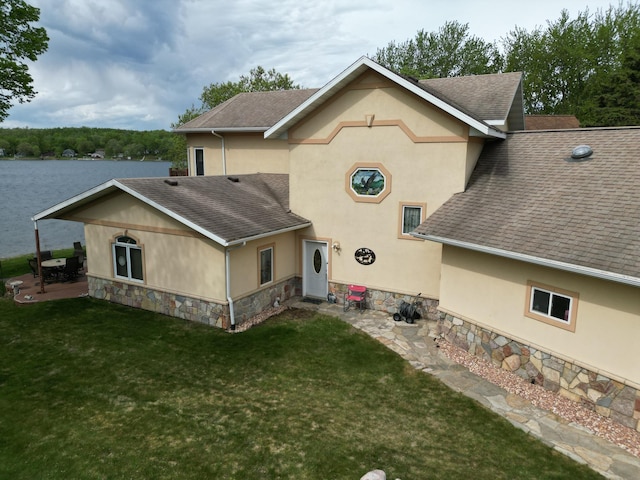 14620 Thomas Rd, Lake Park, MN 56554 - rear view of property featuring roof with shingles, stucco siding, and stone siding