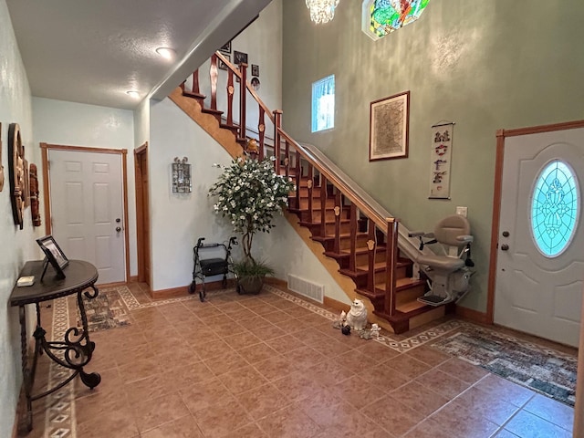 14620 Thomas Rd, Lake Park, MN 56554 - foyer featuring tile patterned floors, stairs, a high ceiling, and baseboards
