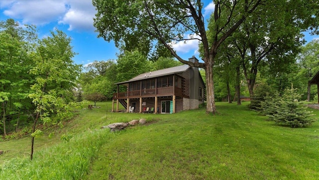 9231 Shady Haven Dr NW, Alexandria, MN 56308 - view of grassy yard with a sunroom, a deck, and stairway