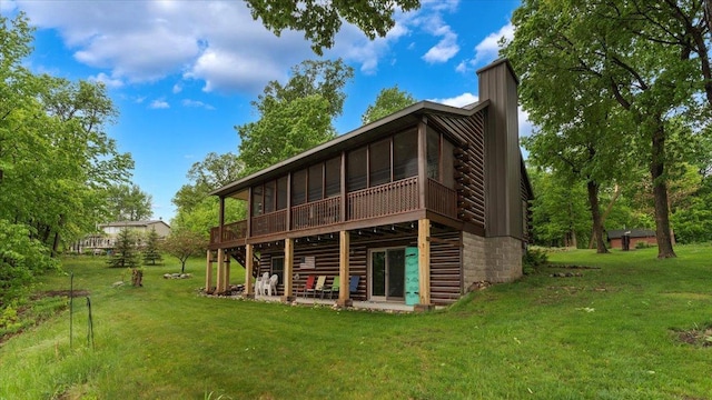 9231 Shady Haven Dr NW, Alexandria, MN 56308 - rear view of house featuring a chimney, a lawn, a wooden deck, and log exterior
