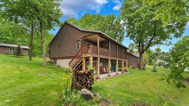 9231 Shady Haven Dr NW, Alexandria, MN 56308 - back of property with log siding, a lawn, a wooden deck, stairs, and a patio