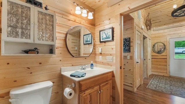 9231 Shady Haven Dr NW, Alexandria, MN 56308 - bathroom with wood walls, wood finished floors, toilet, wood ceiling, and vanity