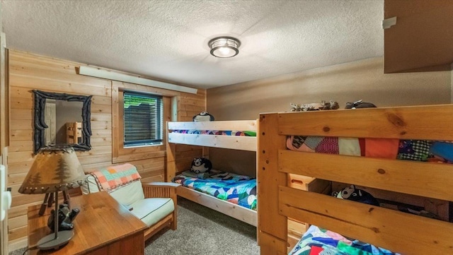 9231 Shady Haven Dr NW, Alexandria, MN 56308 - carpeted bedroom featuring wooden walls and a textured ceiling