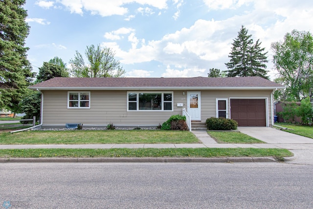 1613 13th Ave N, Moorhead, MN 56560 - single story home with an attached garage, concrete driveway, and a front lawn