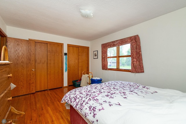 1613 13th Ave N, Moorhead, MN 56560 - bedroom featuring two closets and wood finished floors