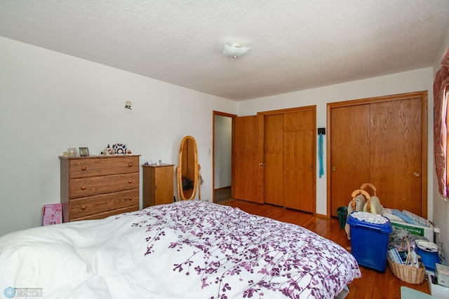 1613 13th Ave N, Moorhead, MN 56560 - bedroom featuring wood finished floors and multiple closets