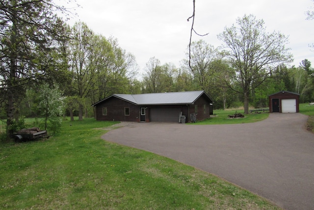 4054 Aspen Rd, Barnum Twp, MN 55767 - view of front of property featuring driveway, a front yard, view of scattered trees, metal roof, and a garage