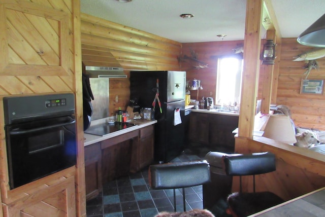 4054 Aspen Rd, Barnum Twp, MN 55767 - kitchen with black appliances and rustic walls