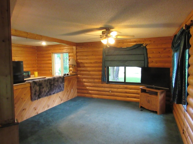 4054 Aspen Rd, Moose Lake, MN 55767 - unfurnished living room featuring a ceiling fan, carpet, rustic walls, and a textured ceiling