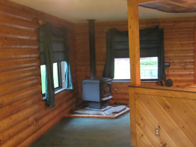 4054 Aspen Rd, Moose Lake, MN 55767 - detailed view of rustic walls, a wood stove, and carpet