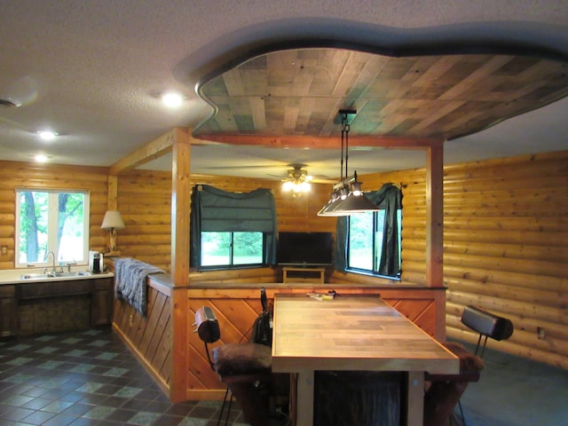4054 Aspen Rd, Moose Lake, MN 55767 - dining room with log walls, ceiling fan, and dark tile patterned floors
