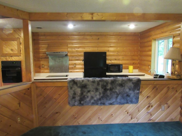 4054 Aspen Rd, Moose Lake, MN 55767 - kitchen with black appliances, recessed lighting, log walls, beamed ceiling, and under cabinet range hood