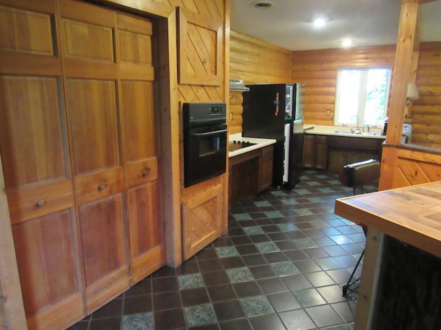 4054 Aspen Rd, Moose Lake, MN 55767 - kitchen with black appliances, rustic walls, ventilation hood, butcher block countertops, and brown cabinets