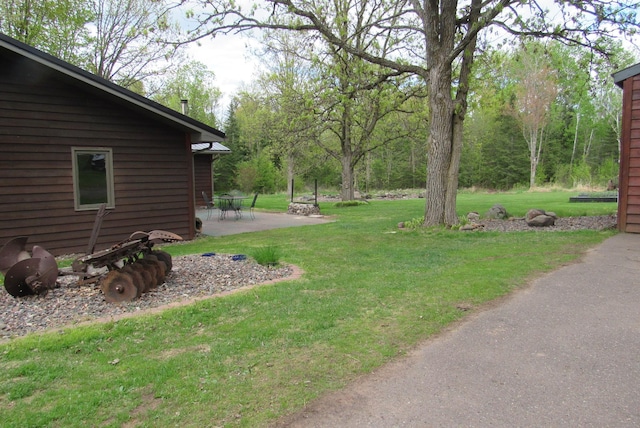 4054 Aspen Rd, Moose Lake, MN 55767 - view of green lawn featuring a patio area