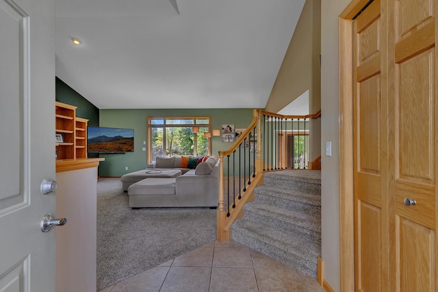 23807 Brendan Way, Rogers, MN 55374 - stairway with carpet floors, vaulted ceiling, baseboards, and tile patterned floors