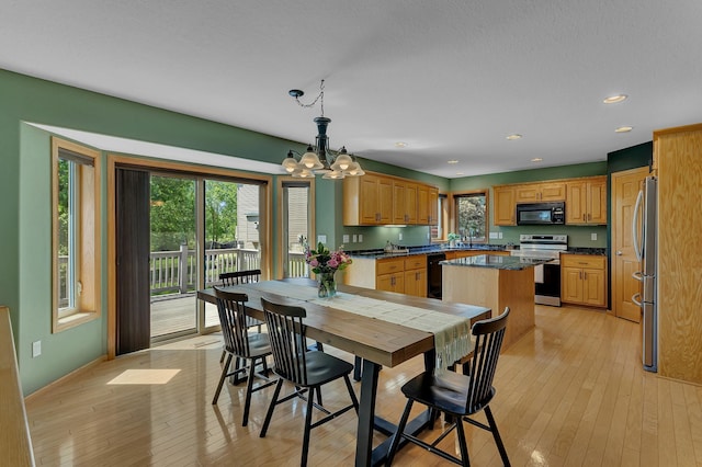 23807 Brendan Way, Rogers, MN 55374 - dining space with a chandelier, light wood finished floors, recessed lighting, and baseboards