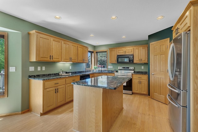 23807 Brendan Way, Rogers, MN 55374 - kitchen with stainless steel appliances, light wood-style floors, recessed lighting, a kitchen island, and dark stone counters