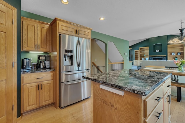 23807 Brendan Way, Rogers, MN 55374 - kitchen with stainless steel fridge, light wood-type flooring, a kitchen island, dark stone countertops, and recessed lighting