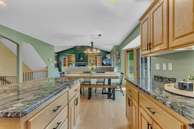 23807 Brendan Way, Rogers, MN 55374 - kitchen featuring lofted ceiling, dark stone countertops, light wood-style floors, a chandelier, and light brown cabinets