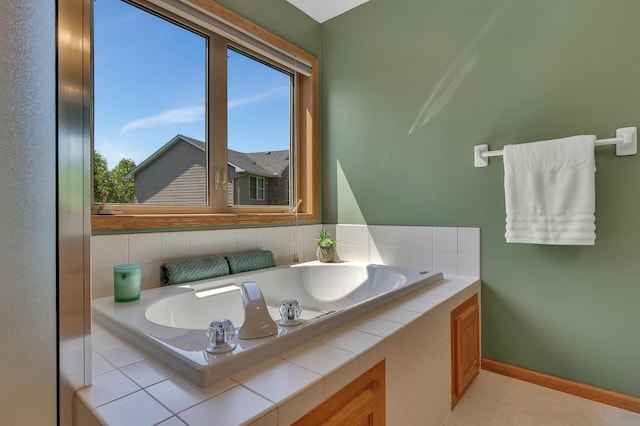 23807 Brendan Way, Rogers, MN 55374 - bathroom featuring a garden tub, baseboards, and tile patterned flooring