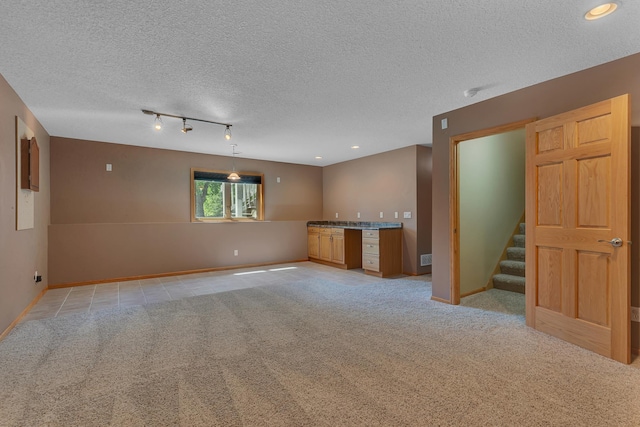 23807 Brendan Way, Rogers, MN 55374 - unfurnished living room featuring light carpet, stairs, a textured ceiling, baseboards, and bar