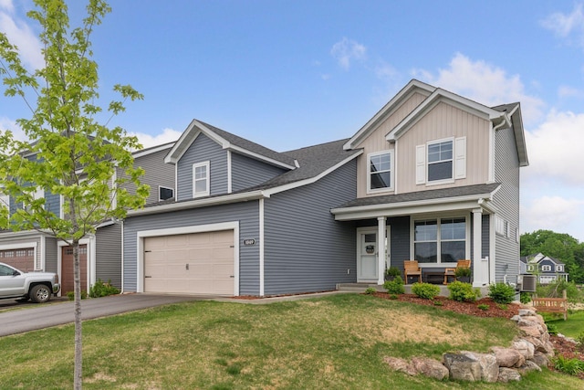 1049 Fabel Ln, Waconia, MN 55387 - view of front of property featuring asphalt driveway, board and batten siding, a porch, central AC, and a front yard