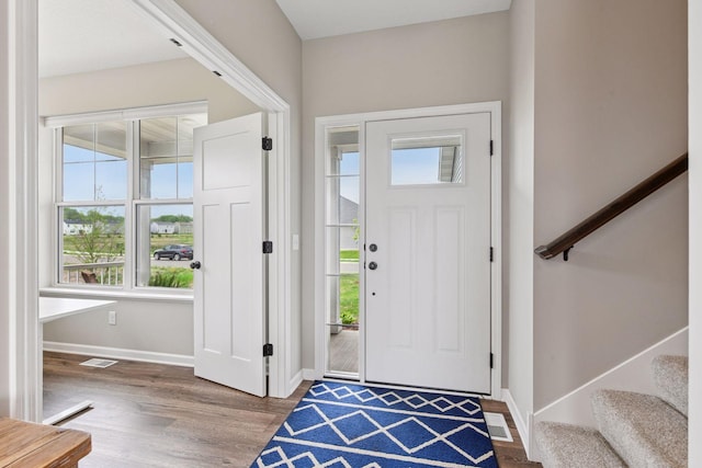 1049 Fabel Ln, Waconia, MN 55387 - foyer featuring wood finished floors, stairway, and baseboards