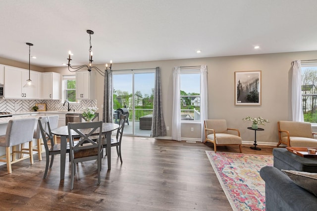 1049 Fabel Ln, Waconia, MN 55387 - dining space featuring plenty of natural light, a chandelier, baseboards, recessed lighting, and dark wood finished floors