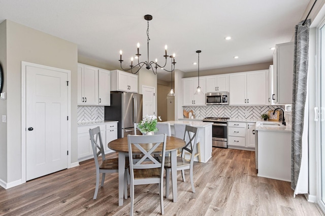 1049 Fabel Ln, Waconia, MN 55387 - dining area with light wood-style floors, a chandelier, and recessed lighting