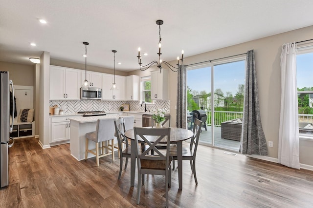 1049 Fabel Ln, Waconia, MN 55387 - dining space featuring wood finished floors, a chandelier, recessed lighting, and baseboards