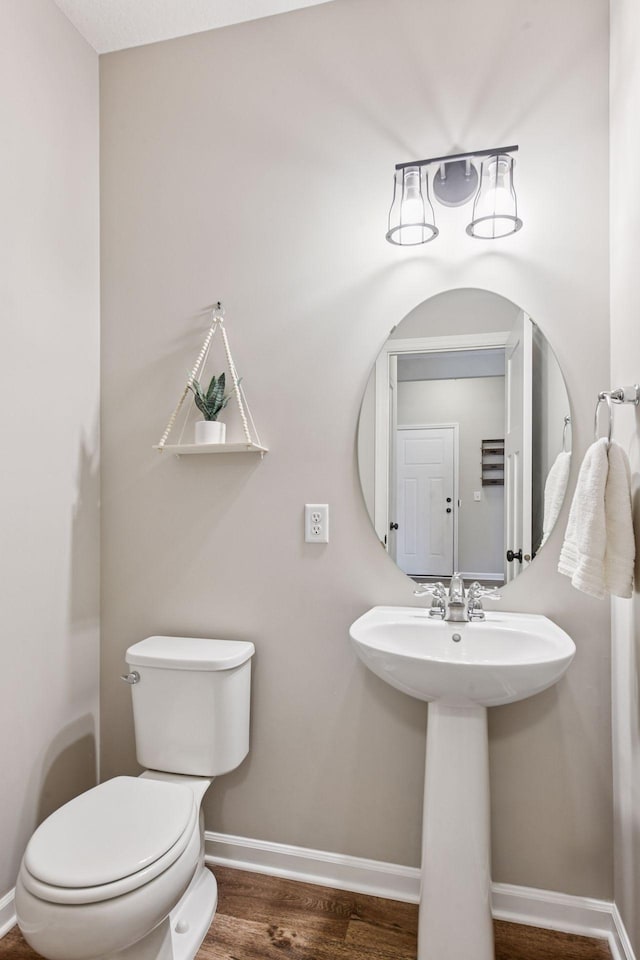 1049 Fabel Ln, Waconia, MN 55387 - bathroom with toilet, baseboards, and wood finished floors